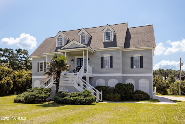 cape cod home with covered porch and a front yard