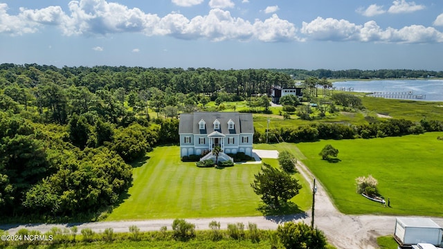 drone / aerial view featuring a water view and a view of trees