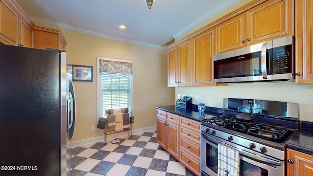 kitchen featuring ornamental molding, light tile patterned floors, dark stone countertops, and stainless steel appliances