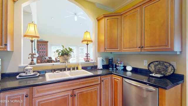 kitchen with dark stone counters, ornamental molding, sink, ceiling fan, and stainless steel dishwasher