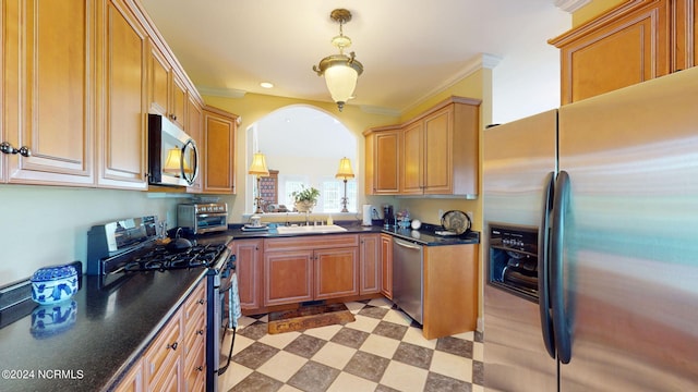 kitchen with ornamental molding, sink, light tile patterned floors, and appliances with stainless steel finishes