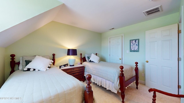 bedroom with lofted ceiling and light colored carpet