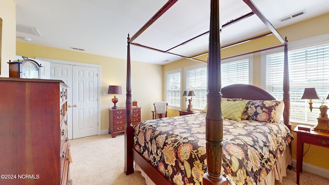 carpeted bedroom featuring visible vents and baseboards