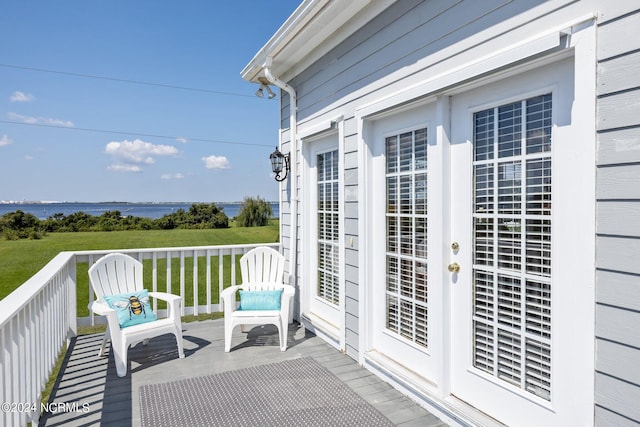 balcony featuring a deck with water view