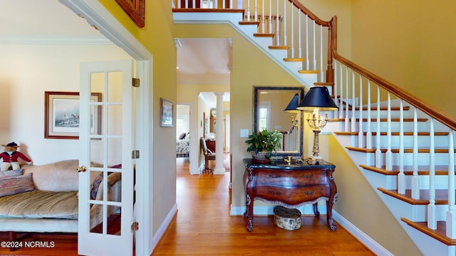 interior space with ornamental molding and wood-type flooring