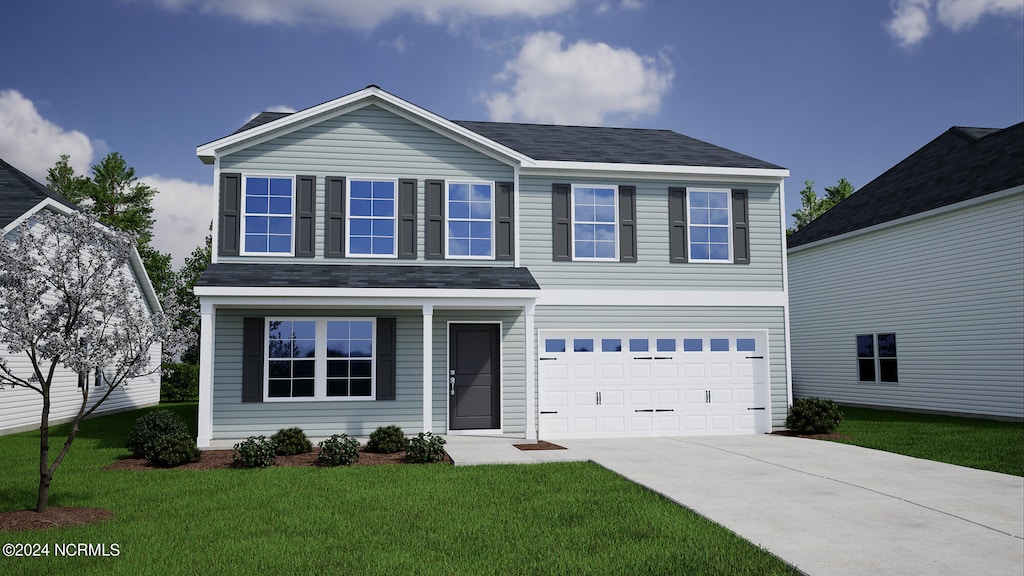 view of front of home with a front yard and a garage