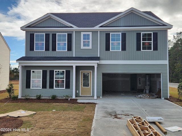 view of front of property featuring a front yard and a garage