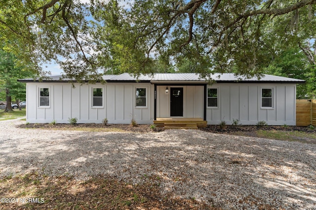 view of front of house with metal roof and board and batten siding