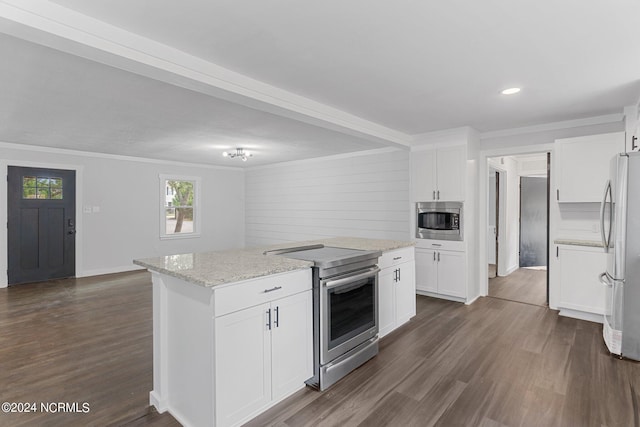 kitchen featuring stainless steel appliances, a center island, white cabinets, and dark wood-type flooring