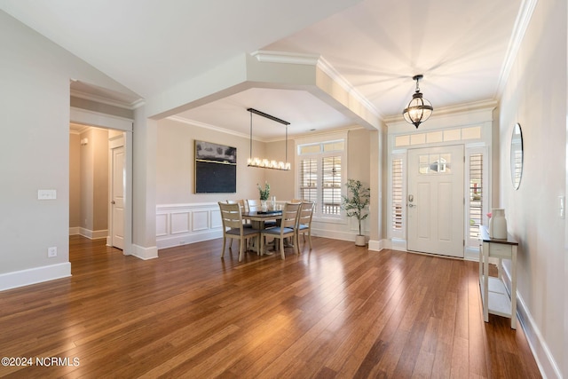 entryway with a chandelier, hardwood / wood-style flooring, and crown molding