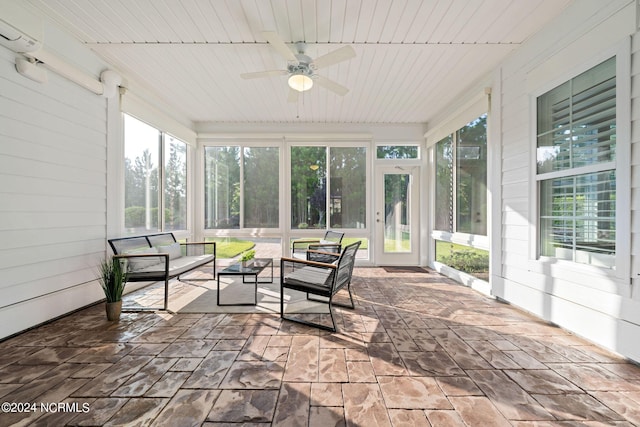 sunroom / solarium featuring a ceiling fan, wooden ceiling, and a healthy amount of sunlight