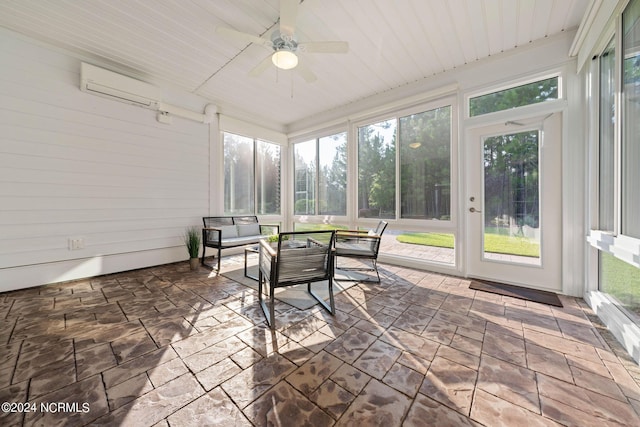 sunroom with a ceiling fan, wood ceiling, a wall mounted air conditioner, and plenty of natural light