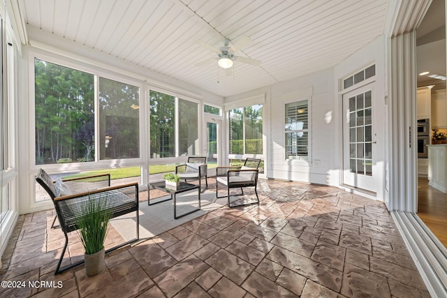 sunroom / solarium featuring ceiling fan and wooden ceiling