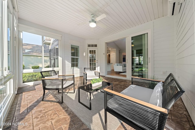 sunroom / solarium featuring ceiling fan