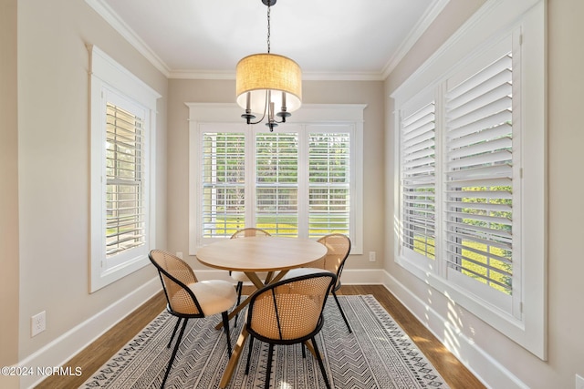 dining space featuring dark wood-style floors, baseboards, and ornamental molding