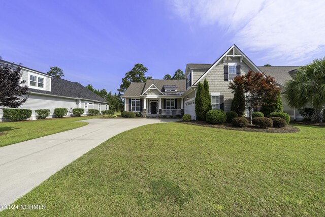 view of front of property featuring a garage and a front yard