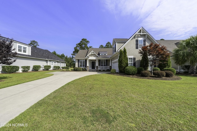 view of front of house with a garage, a front yard, and concrete driveway