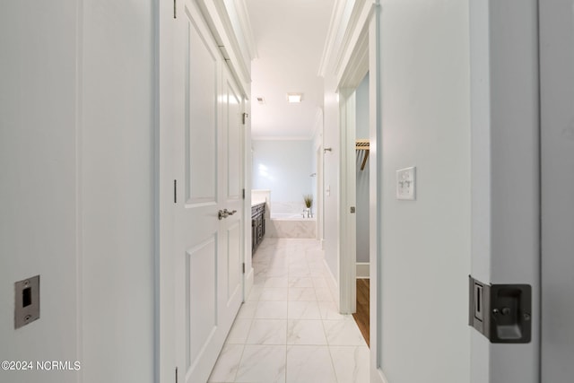 hallway with marble finish floor and ornamental molding