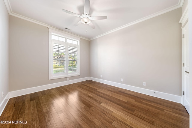 spare room with baseboards, visible vents, ceiling fan, dark wood-type flooring, and crown molding