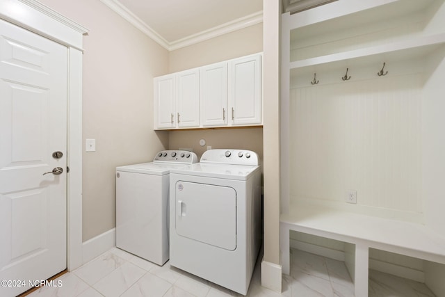 laundry room with washing machine and dryer, baseboards, marble finish floor, ornamental molding, and cabinet space