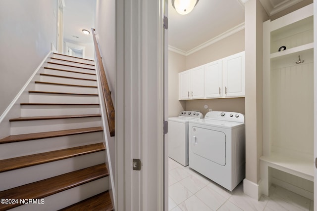 laundry room with marble finish floor, crown molding, and washing machine and clothes dryer