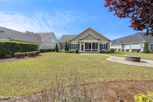 view of front facade with a sunroom and a front lawn