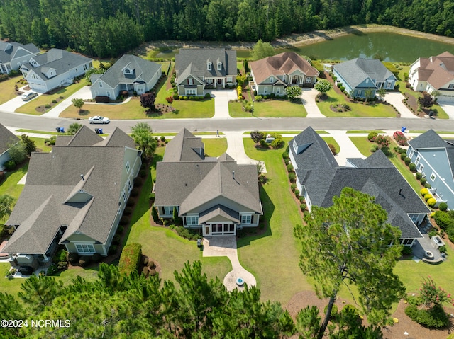 birds eye view of property featuring a water view and a residential view