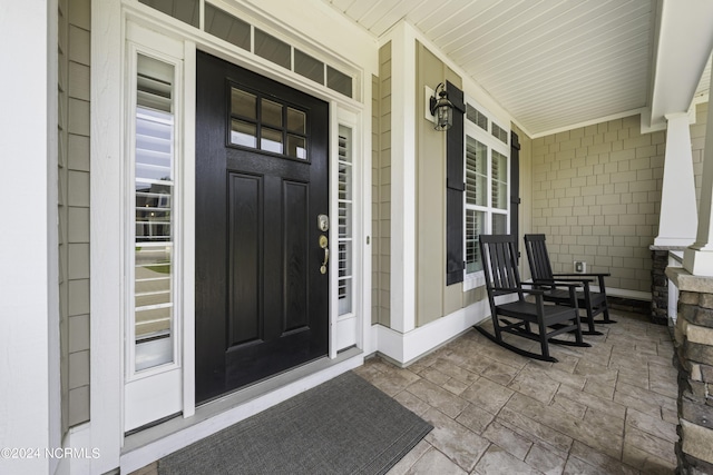 doorway to property featuring covered porch