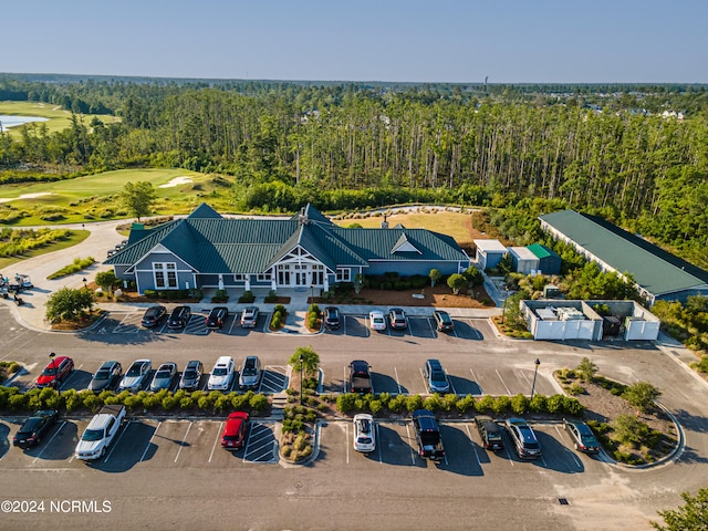 birds eye view of property with golf course view and a view of trees