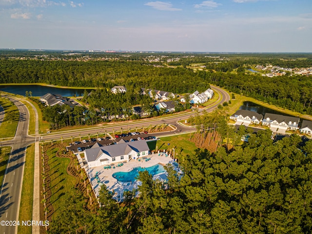 birds eye view of property with a water view and a view of trees