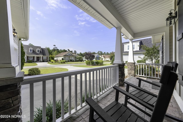 balcony with covered porch and a residential view