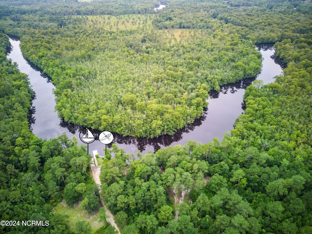 drone / aerial view featuring a water view and a wooded view