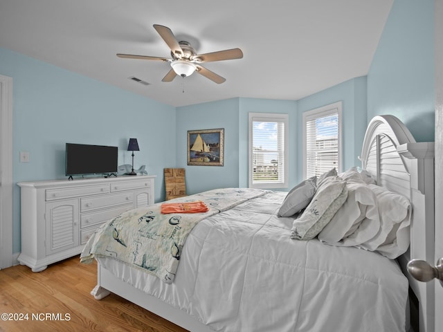 bedroom with light hardwood / wood-style flooring and ceiling fan