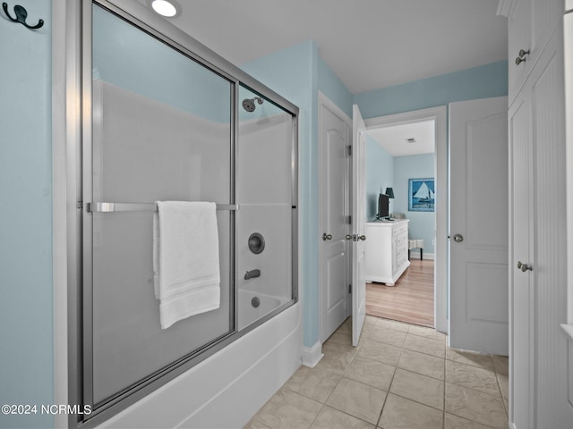 bathroom featuring combined bath / shower with glass door