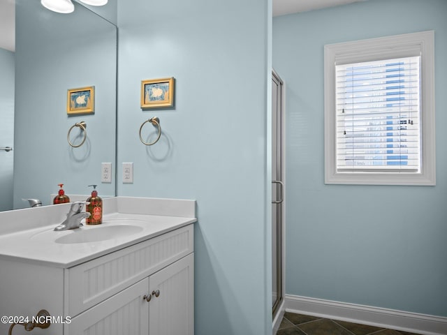 bathroom with vanity, an enclosed shower, and tile patterned flooring