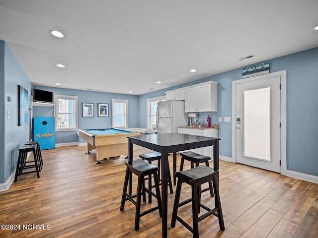 dining space with sink, billiards, and light wood-type flooring