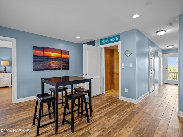 dining space with hardwood / wood-style floors