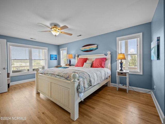 bedroom with ceiling fan and light hardwood / wood-style floors