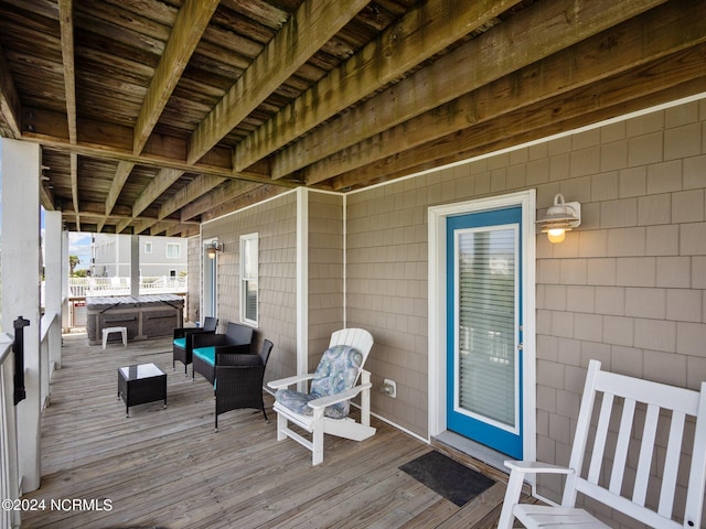 wooden terrace with an outdoor living space