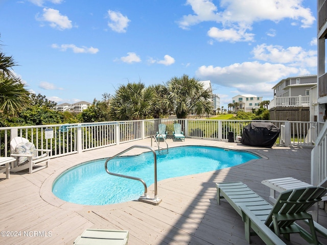 view of swimming pool with a wooden deck