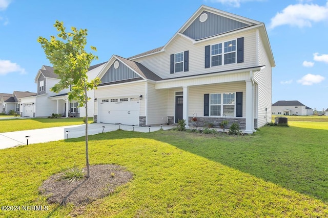 view of front of house with cooling unit, a garage, and a front yard