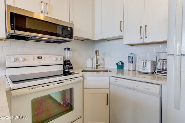 kitchen with white cabinetry, white appliances, sink, and decorative backsplash