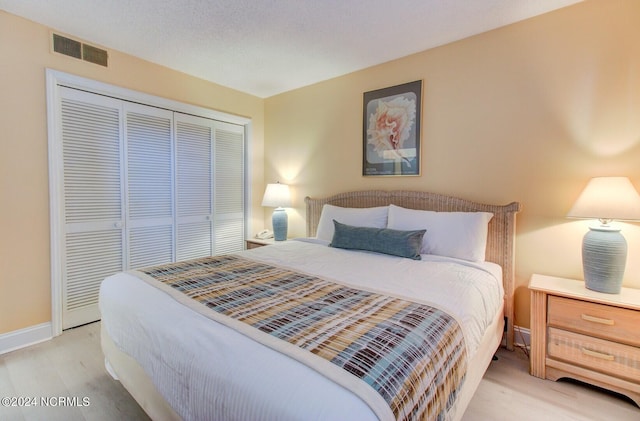 bedroom featuring light hardwood / wood-style floors and a closet