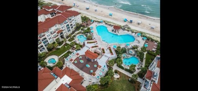 bird's eye view with a water view and a beach view