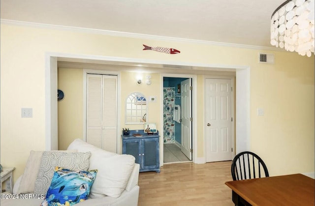 interior space with crown molding and light wood-type flooring