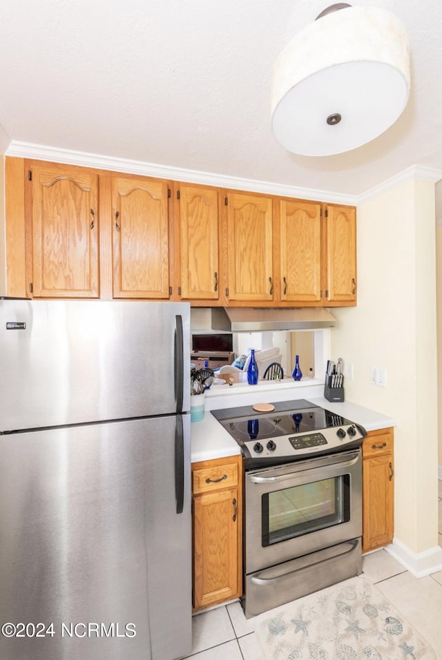 kitchen featuring ornamental molding, appliances with stainless steel finishes, and light tile patterned floors