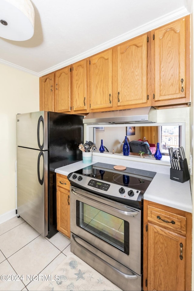 kitchen featuring light tile patterned flooring, appliances with stainless steel finishes, ornamental molding, and range hood