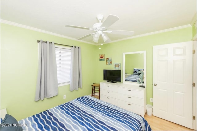 bedroom featuring crown molding, light hardwood / wood-style floors, and ceiling fan