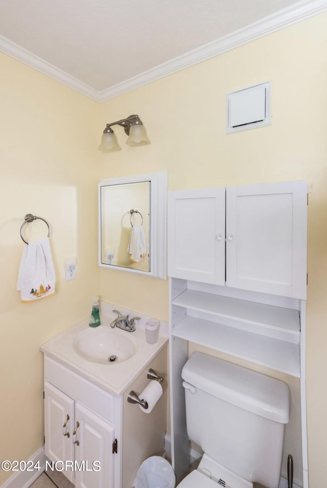 bathroom with vanity, crown molding, and toilet