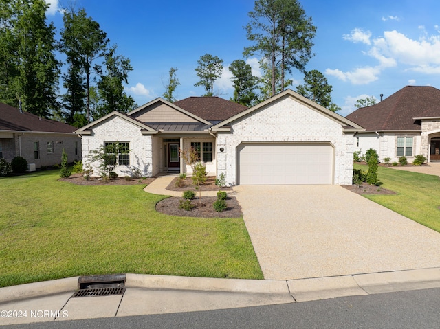 view of front of house featuring a garage and a front lawn